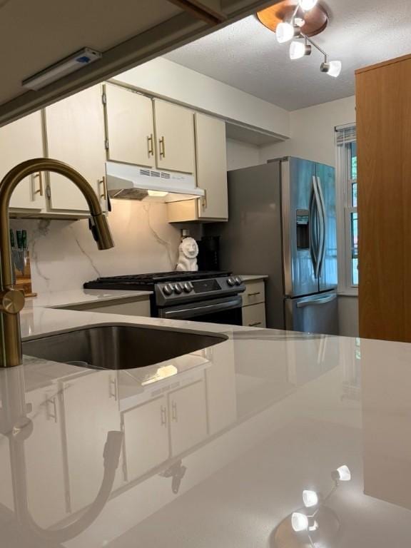 103 Saxonwald Ln, Castle Shannon, PA 15234 - kitchen featuring under cabinet range hood, stainless steel appliances, white cabinets, light countertops, and decorative backsplash