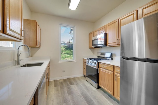 2219 Arlington Ave, South Side, PA 15210 - kitchen with stainless steel appliances, light wood finished floors, light countertops, and plenty of natural light