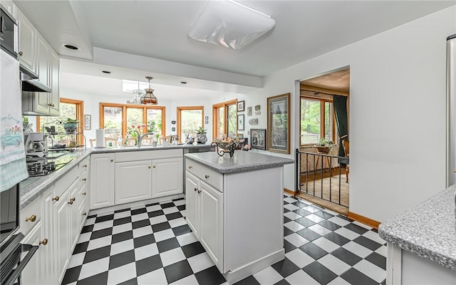 130 Killarney Rd, Pine Twp, PA 15090 - kitchen featuring dark flooring, white cabinetry, a peninsula, and a kitchen island