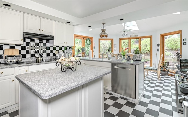 130 Killarney Rd, Pine Twp, PA 15090 - kitchen with stainless steel dishwasher, light flooring, a skylight, and black electric stovetop