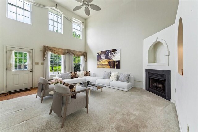 103 Sparrow Ln, Buffalo Twp, PA 16055 - living room with a high ceiling, ceiling fan, plenty of natural light, a fireplace, and arched walkways