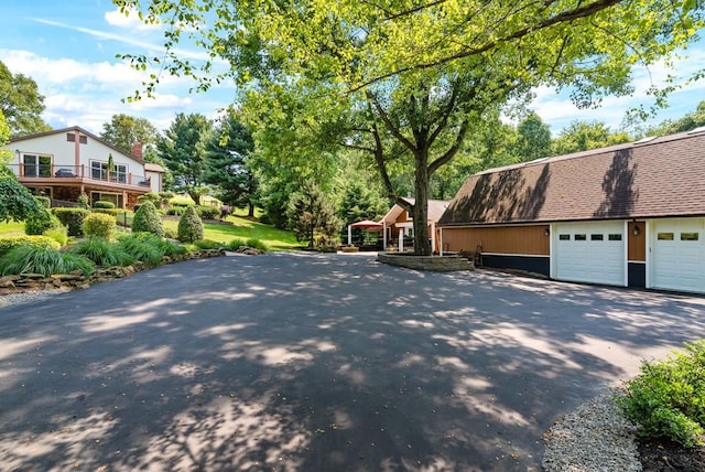 180 Lower Harmony Rd, Connoquenessing Twp, PA 16052 - view of property exterior with asphalt driveway, a shingled roof, and a garage
