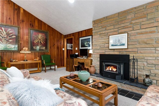 180 Lower Harmony Rd, Connoquenessing Twp, PA 16052 - living area with lofted ceiling, wood walls, a baseboard radiator, and a large fireplace