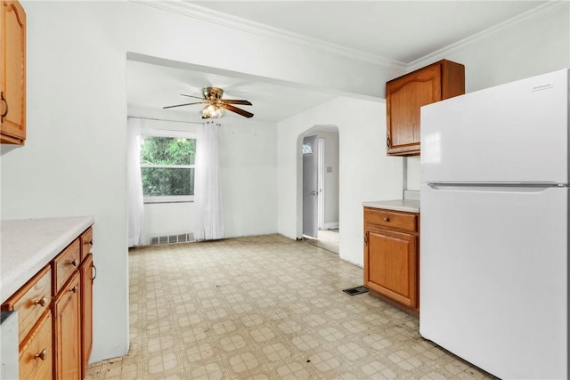 3405 Willett Rd, Baldwin Boro, PA 15227 - kitchen with freestanding refrigerator, arched walkways, light countertops, light floors, and ornamental molding