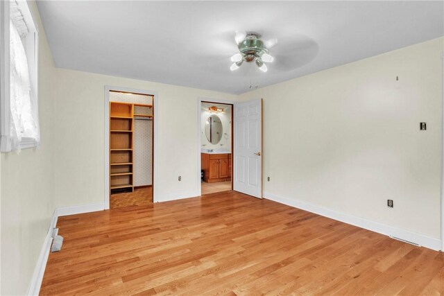 3405 Willett Rd, Baldwin Boro, PA 15227 - unfurnished bedroom with light wood-style flooring, a walk in closet, a closet, and connected bathroom