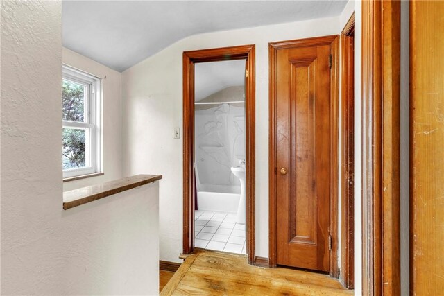 3405 Willett Rd, Baldwin Boro, PA 15227 - hallway featuring vaulted ceiling, light wood-style floors, and an upstairs landing