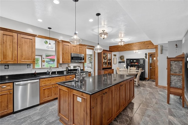 160 Railroad St, Hempfield Twp, PA 15665 - kitchen with stainless steel appliances, dark countertops, an island with sink, brown cabinets, and recessed lighting