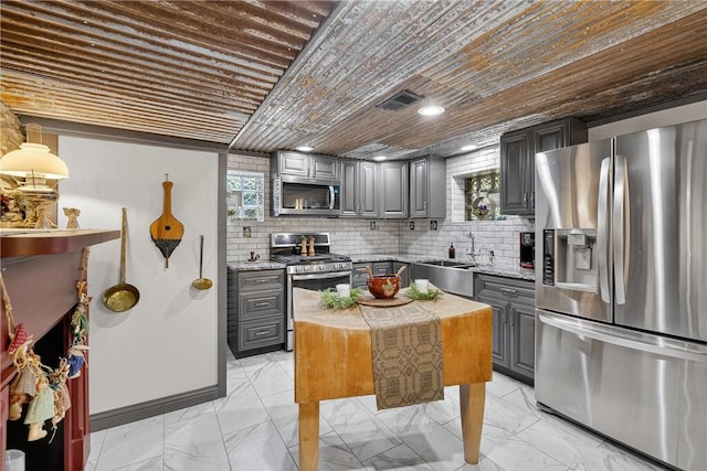 160 Railroad St, Hempfield Twp, PA 15665 - kitchen featuring stainless steel appliances, gray cabinets, light marble finish floors, backsplash, and wood ceiling