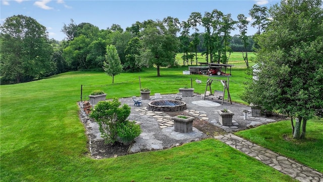 160 Railroad St, Hempfield Twp, PA 15665 - view of green lawn featuring a fire pit, view of scattered trees, and a patio
