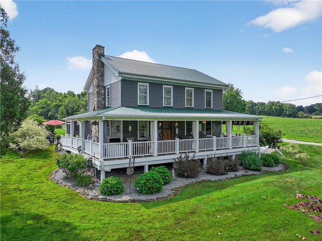160 Railroad St, Hempfield Twp, PA 15665 - farmhouse inspired home with a chimney, a front lawn, a metal roof, and a porch