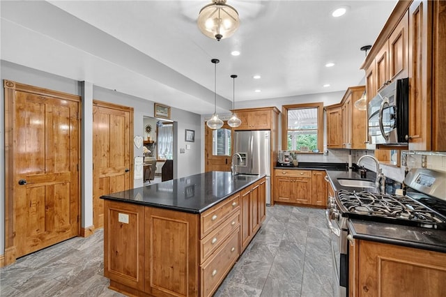 160 Railroad St, Hempfield Twp, PA 15665 - kitchen featuring stainless steel appliances, dark countertops, a center island with sink, brown cabinets, and recessed lighting