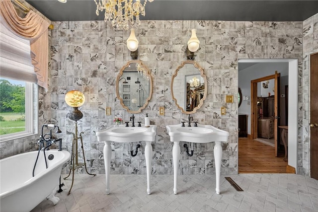 160 Railroad St, Hempfield Twp, PA 15665 - bathroom featuring a freestanding tub and a chandelier