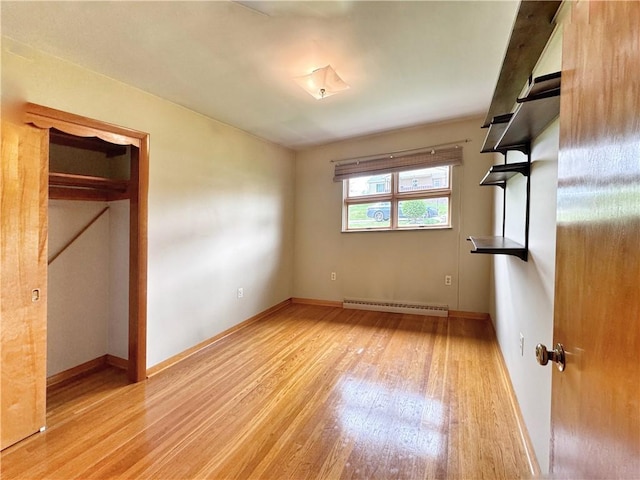 1215 Center Rd, Monaca, PA 15061 - unfurnished bedroom featuring a baseboard radiator, light wood-style floors, and a closet