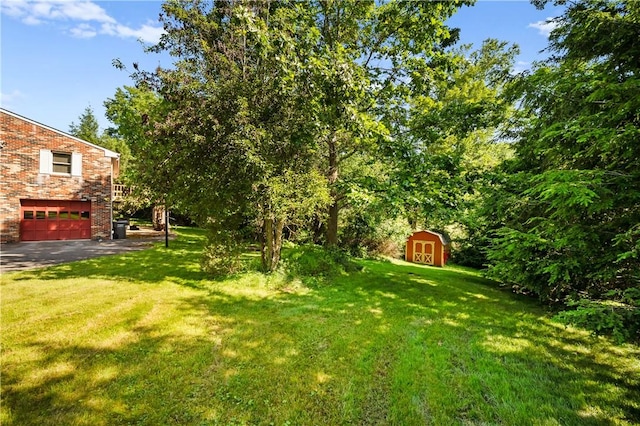 1222 Lakevue Dr, Penn Twp, PA 16002 - view of green lawn featuring a storage unit and an attached garage