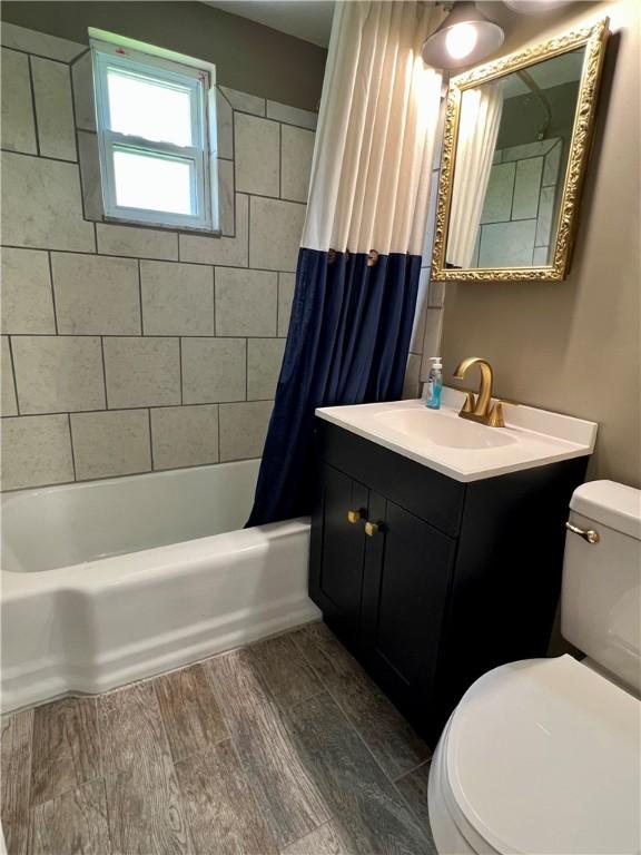 3329 Recker Dr, Baldwin Boro, PA 15227 - full bathroom featuring vanity, shower / bath combination with curtain, and wood finished floors