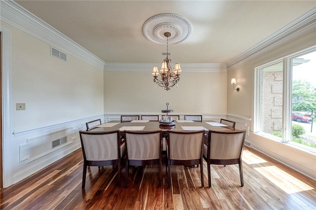 522 Salem Hts, Pine Twp, PA 15044 - dining area with wood-type flooring, a chandelier, crown molding, wainscoting, and a decorative wall