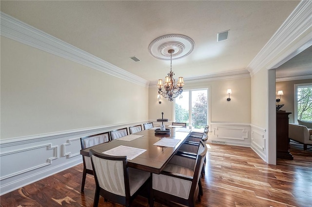 522 Salem Hts, Pine Twp, PA 15044 - dining area featuring ornamental molding, wood finished floors, a chandelier, a decorative wall, and wainscoting