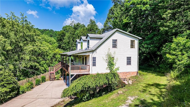 479 Bell Run Rd, Waynsbrg/Frankln Twp, PA 15362 - view of side of home featuring stairs, covered porch, a wooded view, and driveway