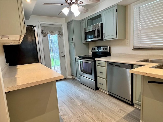 716 Vallevista Ave, Mt Lebanon, PA 15234 - kitchen with appliances with stainless steel finishes, light wood finished floors, light countertops, and ceiling fan