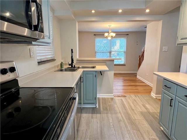 716 Vallevista Ave, Mt Lebanon, PA 15234 - kitchen with stainless steel appliances, a peninsula, light wood finished floors, light countertops, and recessed lighting