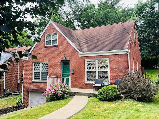716 Vallevista Ave, Mt Lebanon, PA 15234 - english style home featuring brick siding, a shingled roof, a front yard, and a garage