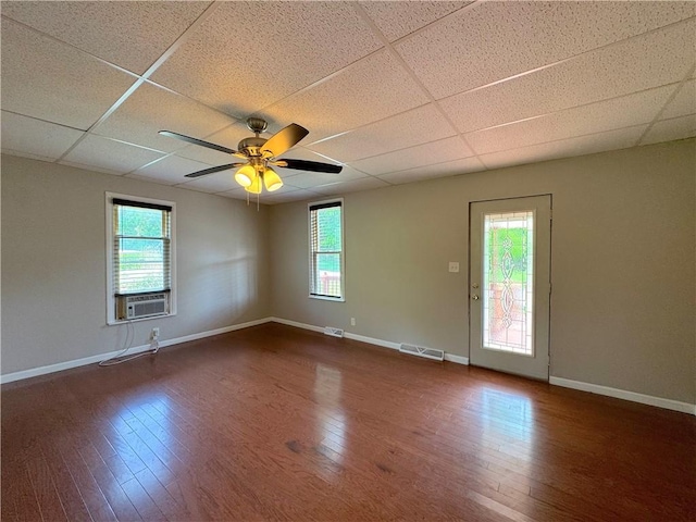81 Baltimore St, Irwin, PA 15642 - unfurnished room with a paneled ceiling, plenty of natural light, dark wood-style floors, and ceiling fan