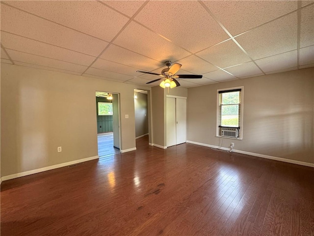 81 Baltimore St, Irwin, PA 15642 - empty room featuring a drop ceiling, healthy amount of natural light, ceiling fan, dark wood-type flooring, and cooling unit