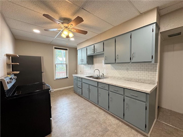 81 Baltimore St, Irwin, PA 15642 - kitchen featuring gray cabinets, range, ceiling fan, light countertops, and decorative backsplash
