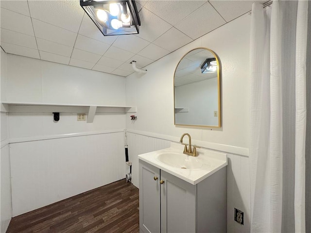 81 Baltimore St, Irwin, PA 15642 - bathroom with vanity, wood finished floors, a wainscoted wall, and a decorative wall