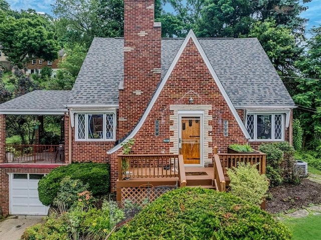 310 Glaser Ave, Bellevue, PA 15202 - tudor house featuring a chimney, a shingled roof, brick siding, and an attached garage