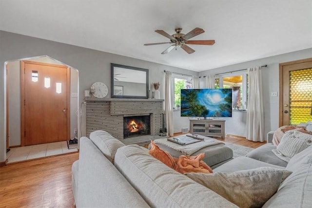 310 Glaser Ave, Bellevue, PA 15202 - living area featuring light wood-type flooring, a ceiling fan, and a lit fireplace