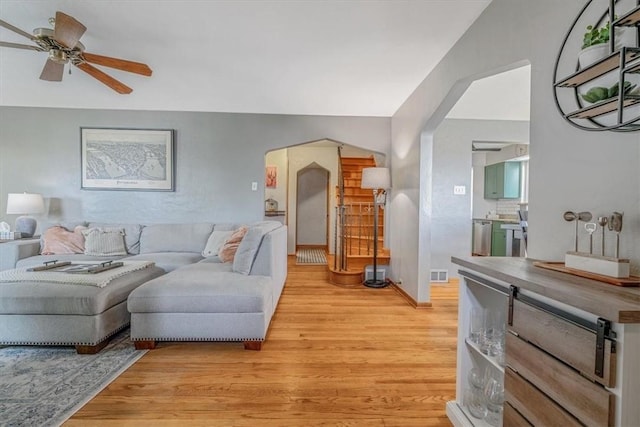 310 Glaser Ave, Bellevue, PA 15202 - living area with arched walkways, light wood-style flooring, and ceiling fan