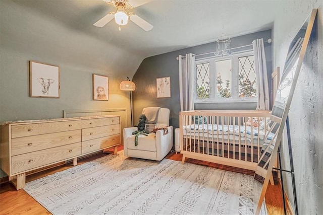 310 Glaser Ave, Bellevue, PA 15202 - bedroom with wood finished floors, a crib, lofted ceiling, and ceiling fan
