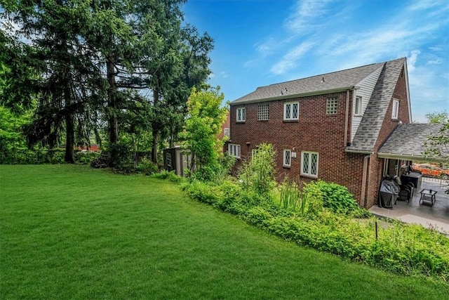 310 Glaser Ave, Bellevue, PA 15202 - rear view of property featuring a patio, a yard, and brick siding