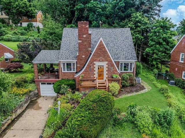 310 Glaser Ave, Bellevue, PA 15202 - english style home featuring a chimney, roof with shingles, driveway, a garage, and a front yard