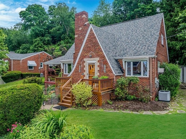 310 Glaser Ave, Bellevue, PA 15202 - view of front of home featuring roof with shingles, a chimney, a deck, a front yard, and brick siding