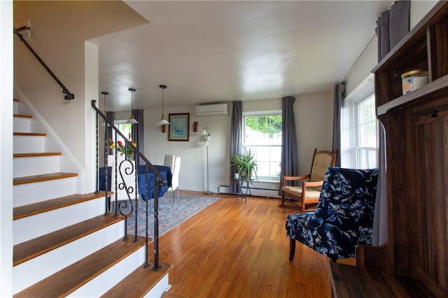 5401 Perrysville Rd, Ross Twp, PA 15229 - living area with stairs, wood finished floors, a wall unit AC, and a baseboard radiator
