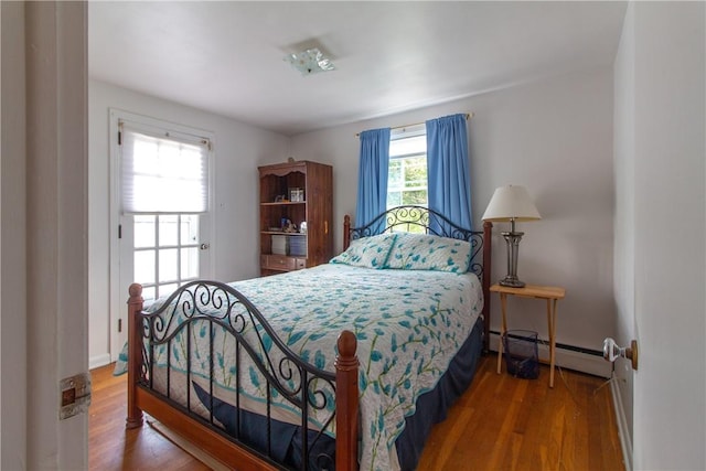 5401 Perrysville Rd, Ross Twp, PA 15229 - bedroom featuring a baseboard radiator and wood finished floors