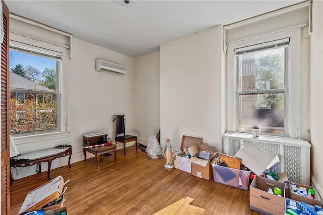 1503 Beechview Ave, Beechview, PA 15216 - recreation room featuring a wall unit AC, plenty of natural light, wood finished floors, and radiator