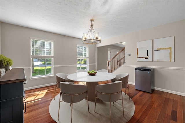 706 Williamsburg Ct, Cranberry Twp, PA 16066 - dining area with a chandelier, wood finished floors, stairway, and a textured ceiling