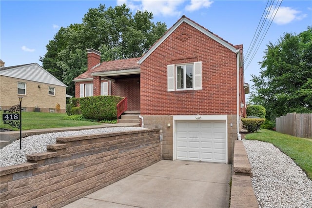 418 Sylvania Dr, Ross Twp, PA 15229 - view of front facade featuring an attached garage, brick siding, concrete driveway, and a chimney