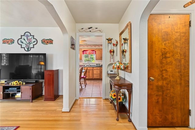 418 Sylvania Dr, Ross Twp, PA 15229 - hallway featuring arched walkways and light wood-style flooring