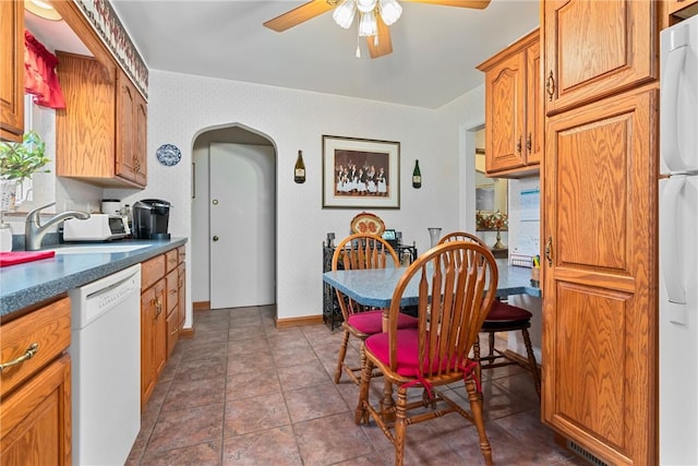 418 Sylvania Dr, Ross Twp, PA 15229 - kitchen featuring white dishwasher, arched walkways, fridge, ceiling fan, and dark countertops