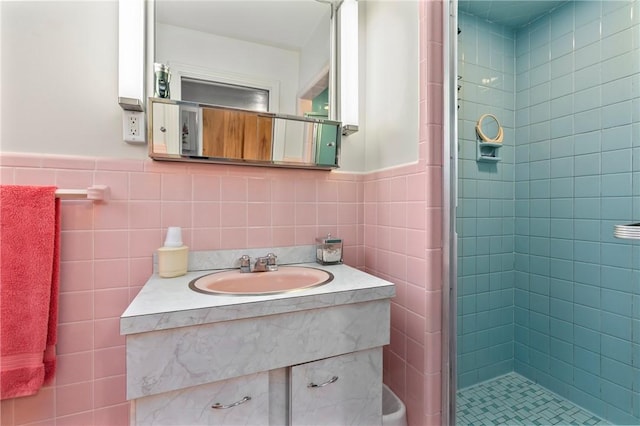 418 Sylvania Dr, Ross Twp, PA 15229 - bathroom with tile walls, a stall shower, vanity, and wainscoting