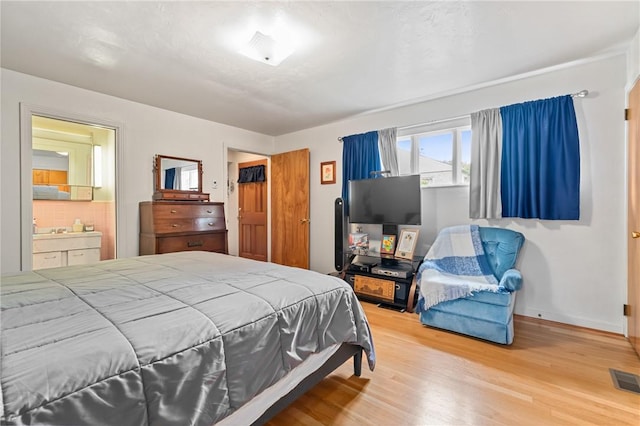 418 Sylvania Dr, Ross Twp, PA 15229 - bedroom featuring wood finished floors and connected bathroom