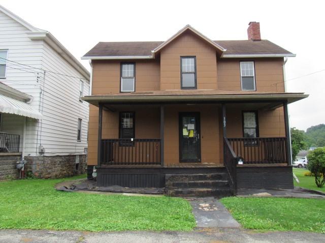 103 Memorial St, Dunbar, PA 15431 - view of front facade with covered porch, a chimney, and a front lawn