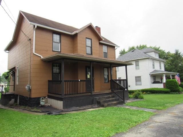 103 Memorial St, Dunbar, PA 15431 - view of front of home with covered porch, a chimney, and a front yard