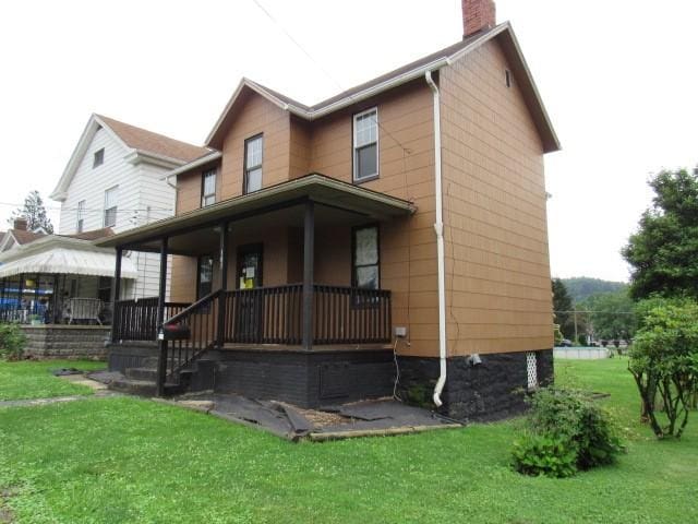 103 Memorial St, Dunbar, PA 15431 - rear view of house with covered porch, a chimney, and a yard