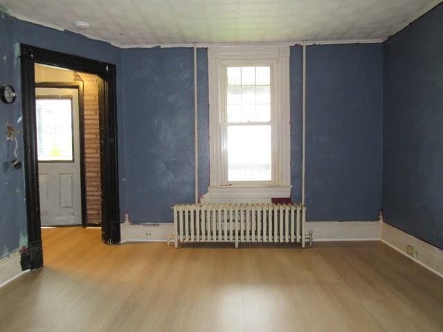103 Memorial St, Dunbar, PA 15431 - spare room with radiator heating unit and wood finished floors
