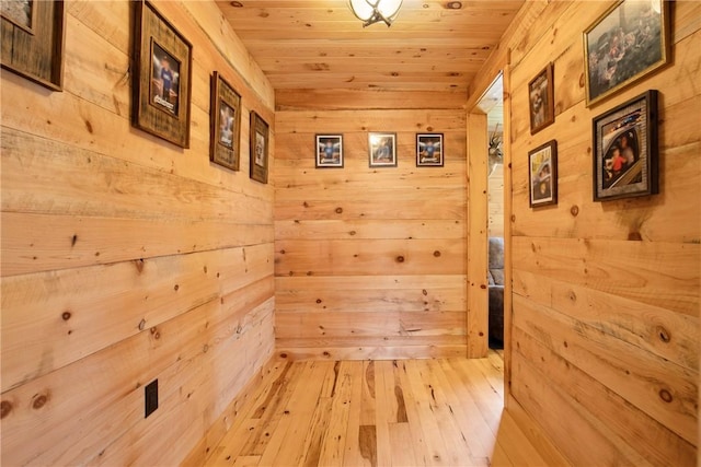 1171 Dividing Ridge Rd, Allegheny Twp, PA 15538 - hallway featuring wood walls, wooden ceiling, and light wood-style flooring